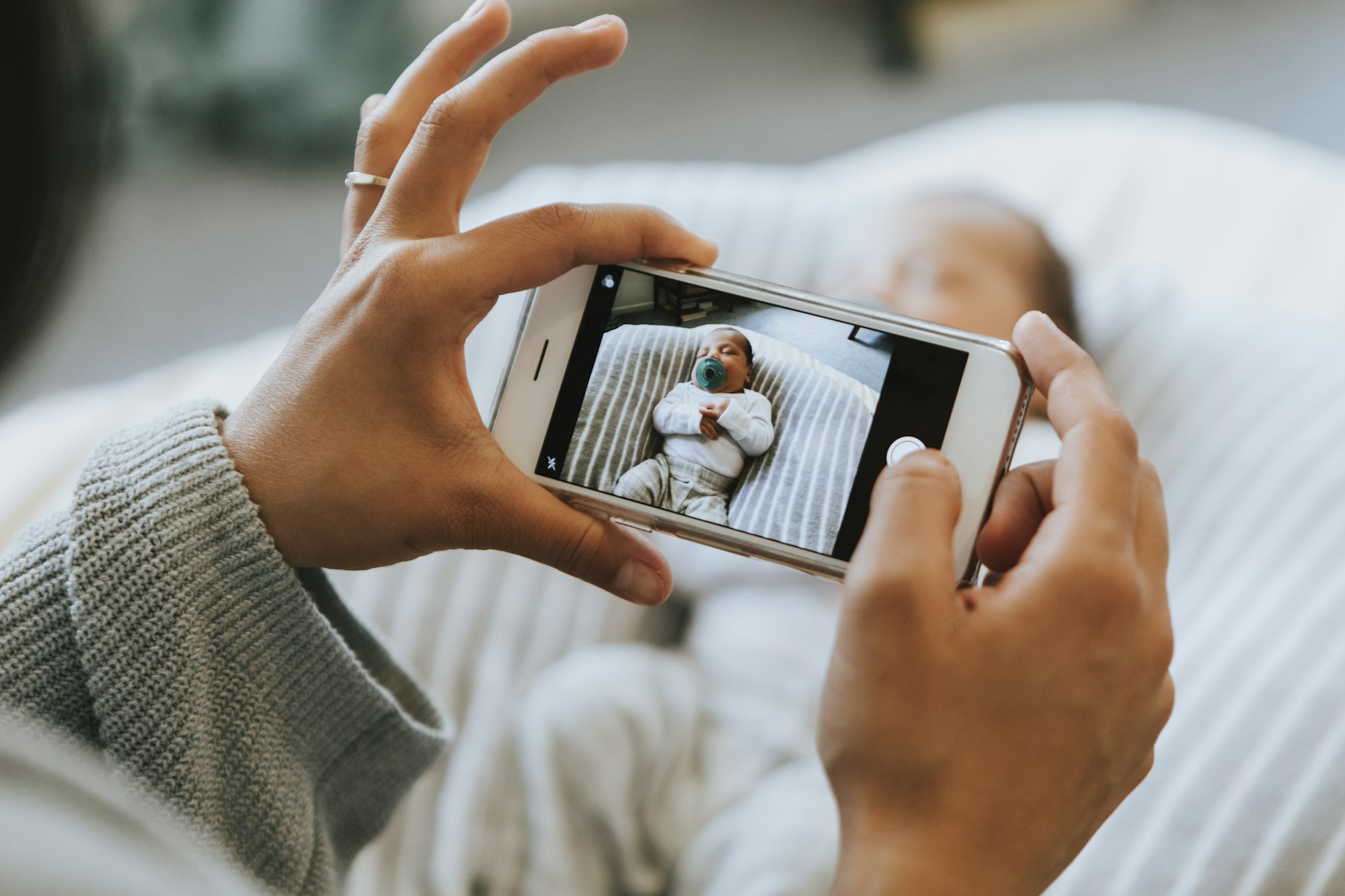 Mother snapping a photo of her newborn