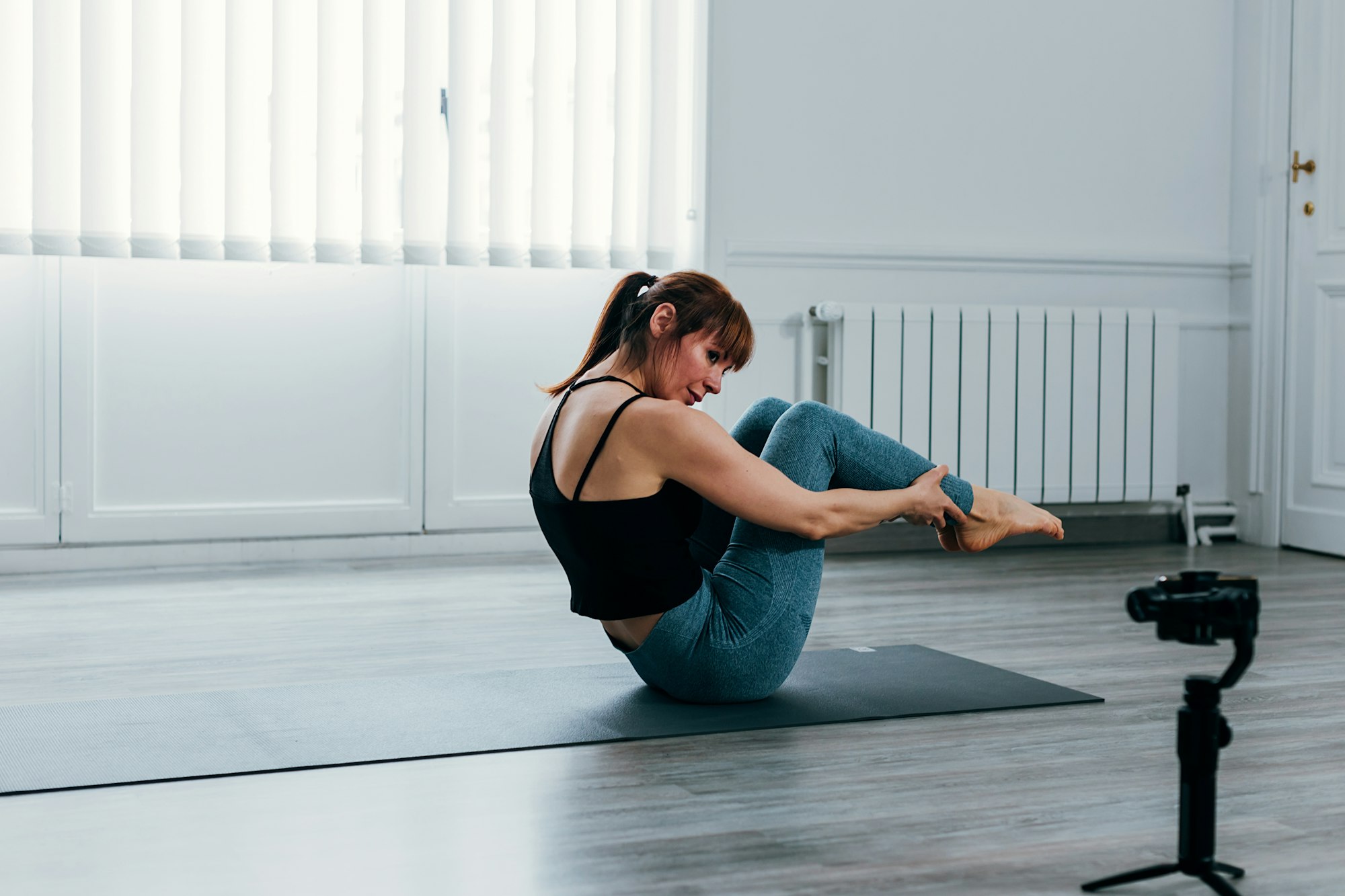 sportswoman records a gymnastics course to upload online